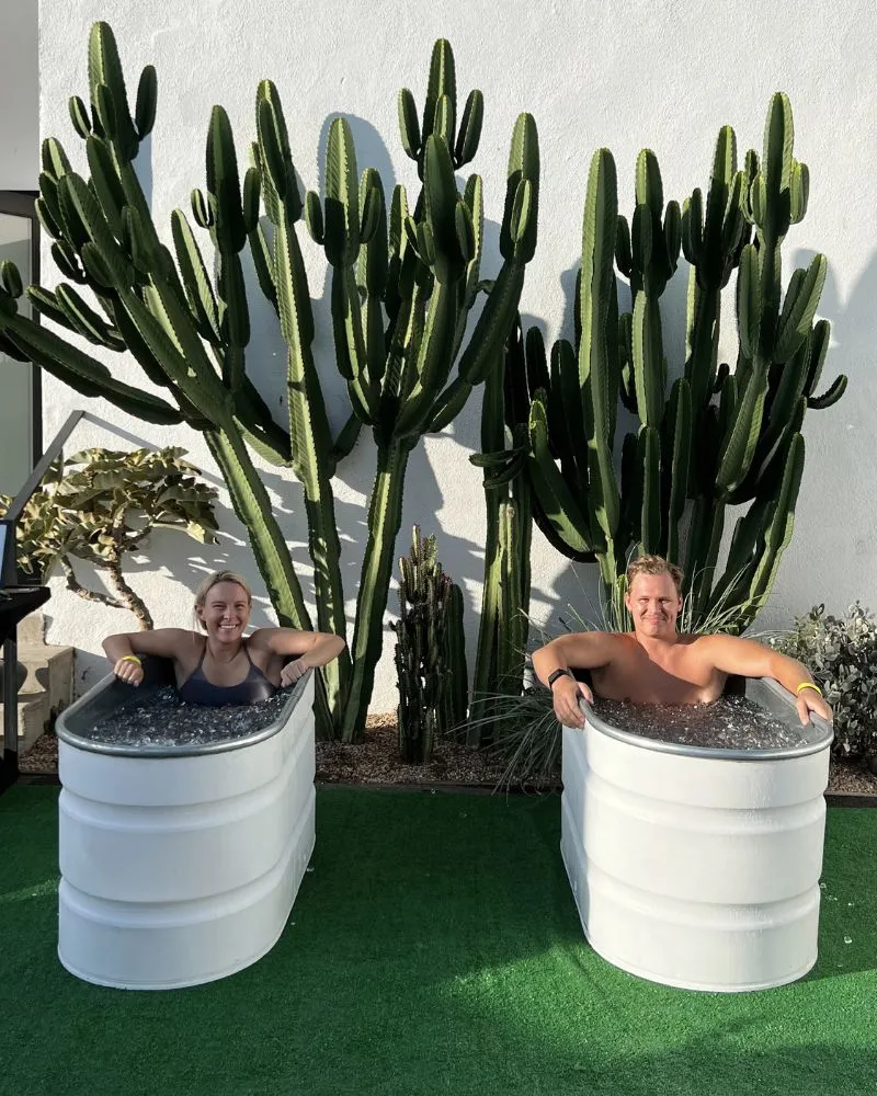 A photo of two people in two separate ice baths